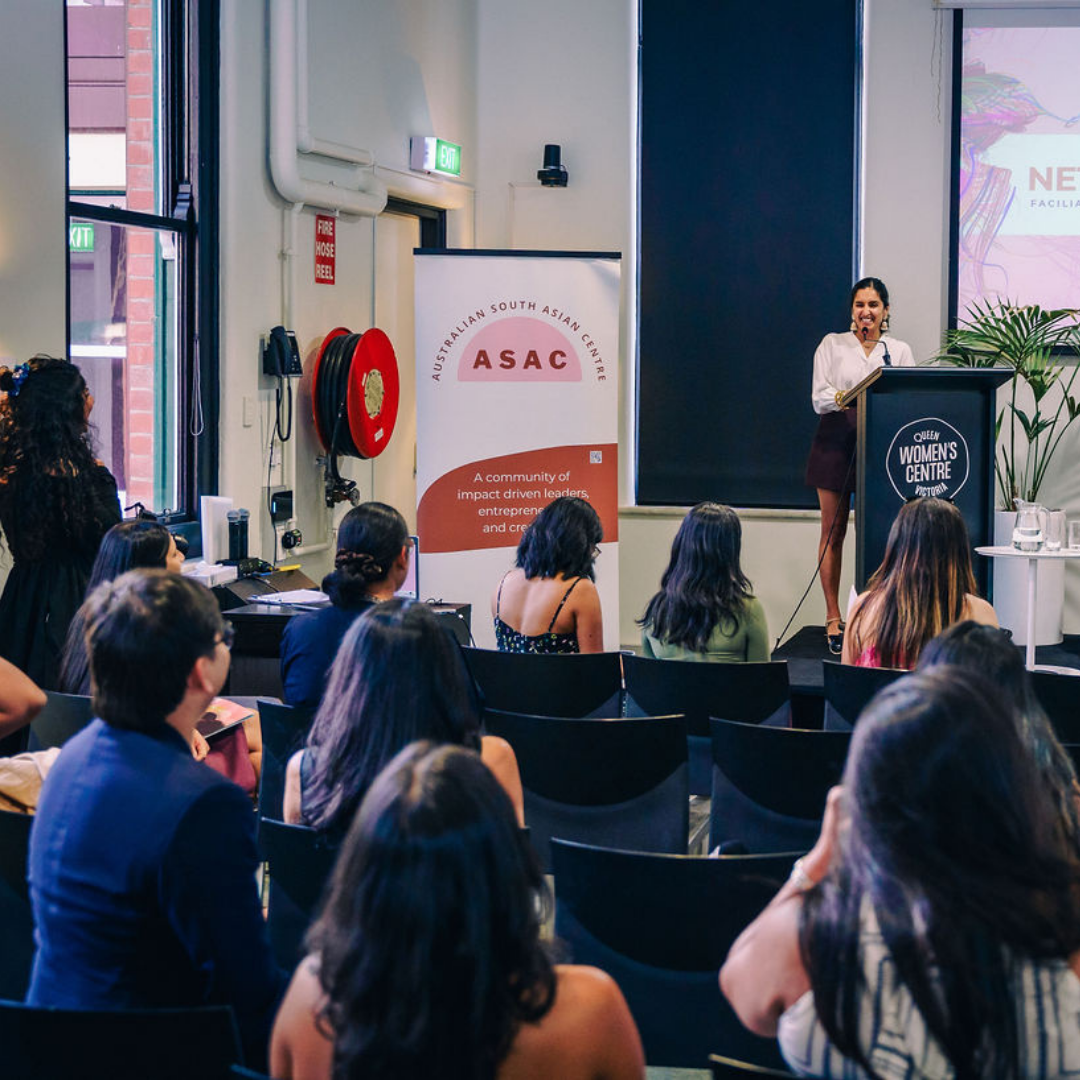 A speaker presents at an ASAC event as attendees listen inside the Queen Victoria Women’s Centre.